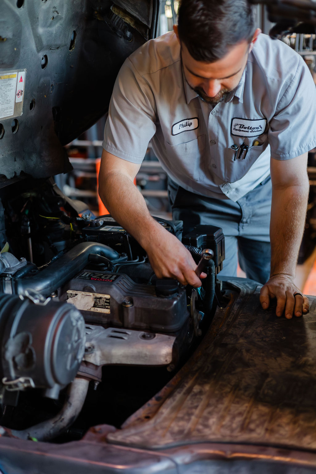 Bolton technician Philip working on a Toyota forklift engine in the Thibodaux shop