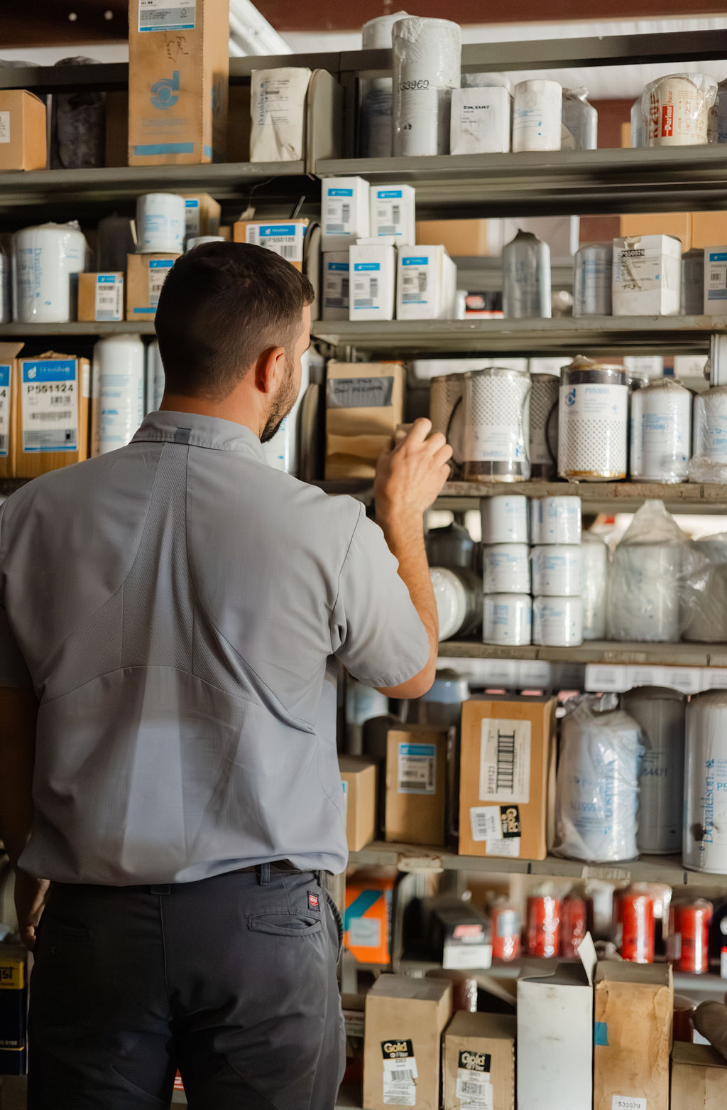 Bolton Equipment parts specialist pulling filters from the Thibodaux parts room shelves